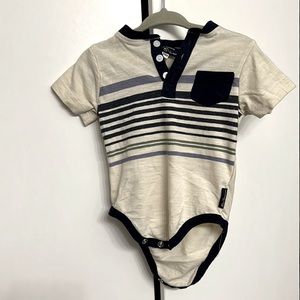 Tan button- up onesie w/ purple, blue, green stripes. White buttons. Frocket.